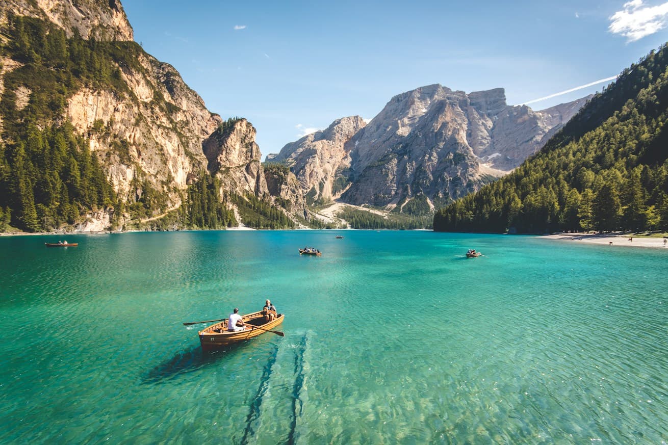 Rowing boat on a clear turquoise mountain lake
